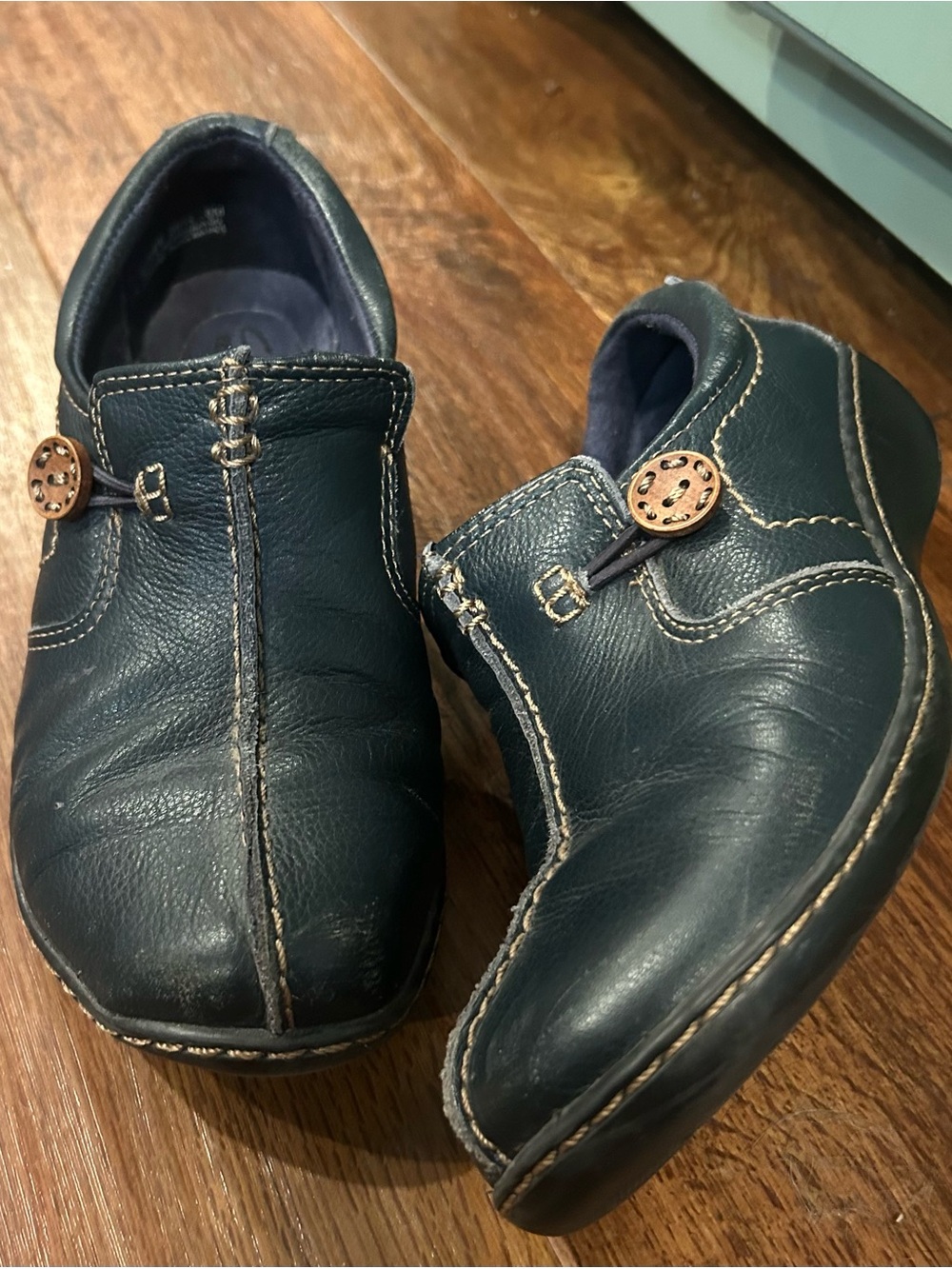 Clarks Women's Moccasin Stitch Slip On Shoes in Deep Teal Blue with Brown Button